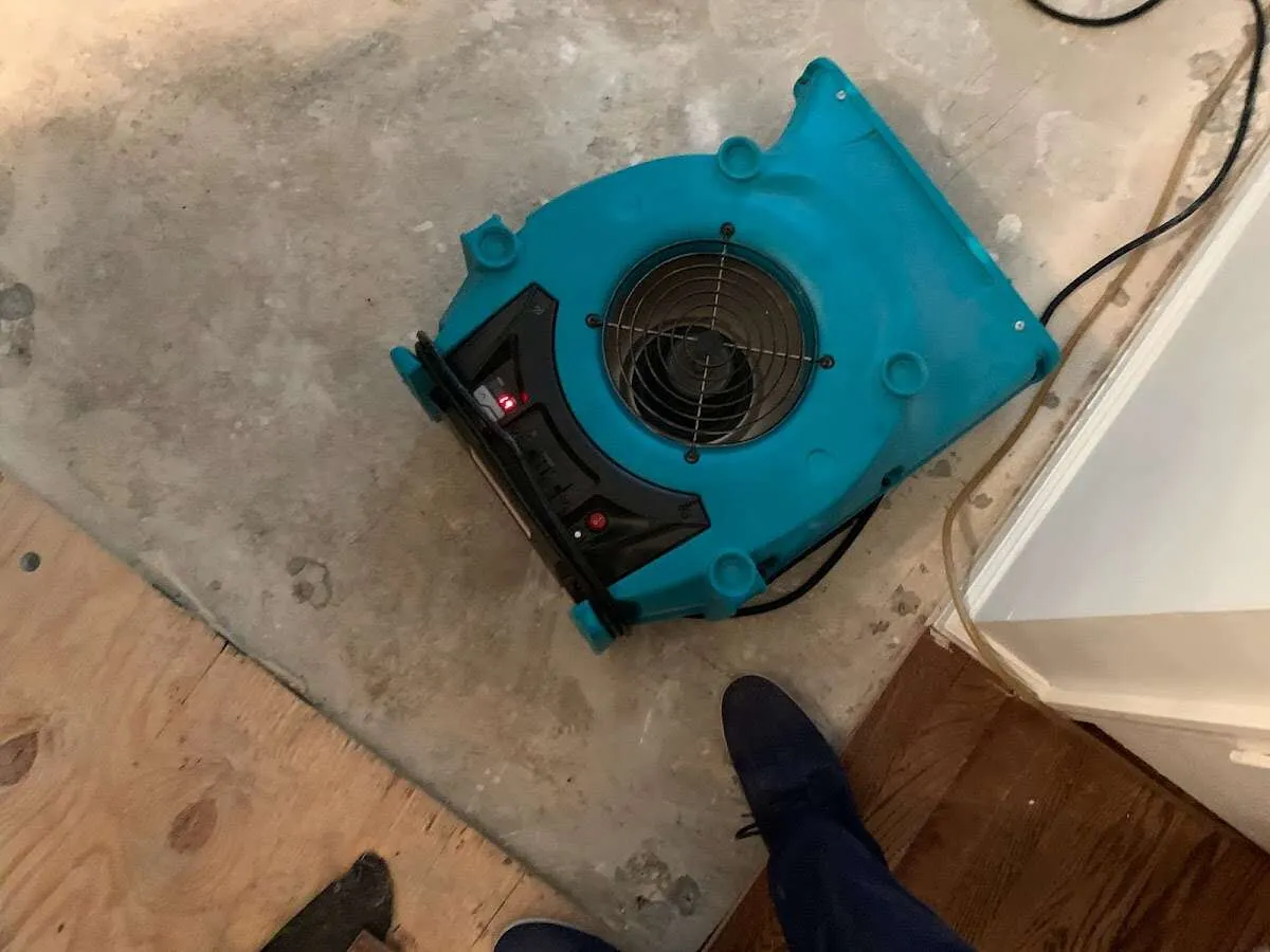 Air mover drying subfloor during Commercial Water Damage Restoration in Peoria